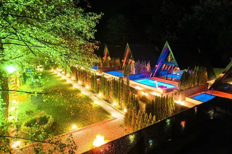 Sapanca Oksijen Bungalov evlerinin gece görünümü, özel havuzlar ve yeşilliklerle çevrili.